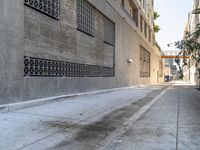 this is a narrow street with an old building on it and a fire hydrant