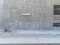 two doors and a fire hydrant are standing against the wall of a building,