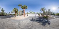 the same view is shown in this 360 - ray of an outdoor area, with palm trees and a paved street