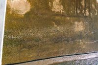 a person laying on the side of a cement wall with an umbrella in hand and another standing near