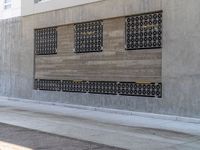 the woman is running down the sidewalk while on her cellphone is near a building