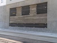 the woman is running down the sidewalk while on her cellphone is near a building