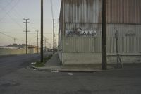 a corner is covered with street signs and poles near the side of a building that says