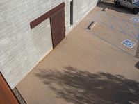 a picture of a car parked outside of a building with one door and one window open