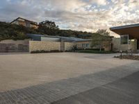 an outdoor courtyard with lots of parking space on the side of it with a sky background