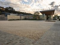 an outdoor courtyard with lots of parking space on the side of it with a sky background