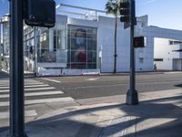 a picture is shown from across the street in front of a modern building on a quiet day