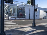 a picture is shown from across the street in front of a modern building on a quiet day