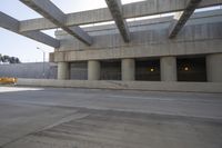 a car that is driving in front of an underground parking lot where no people are standing