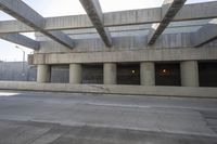 a car that is driving in front of an underground parking lot where no people are standing