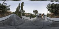 a circular panorama photo taken in the middle of a cement bowl with trees growing at the side