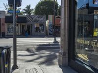 the sidewalk in front of a building on a street corner with a sign that says hannaie ice creams