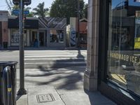 the sidewalk in front of a building on a street corner with a sign that says hannaie ice creams