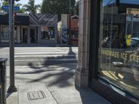 the sidewalk in front of a building on a street corner with a sign that says hannaie ice creams