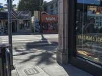 the sidewalk in front of a building on a street corner with a sign that says hannaie ice creams