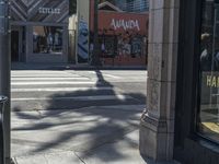 the sidewalk in front of a building on a street corner with a sign that says hannaie ice creams