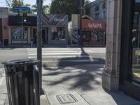 the sidewalk in front of a building on a street corner with a sign that says hannaie ice creams