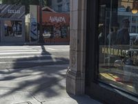 the sidewalk in front of a building on a street corner with a sign that says hannaie ice creams