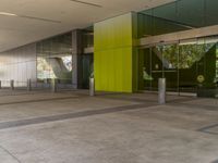 an empty building is decorated in a bright green colorway, including several glass panels