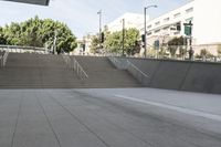 a man on a skateboard going down stairs in front of a building with trees