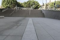 a man on a skateboard going down stairs in front of a building with trees