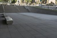 a man on a skateboard going down stairs in front of a building with trees