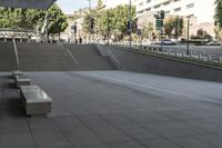 a man on a skateboard going down stairs in front of a building with trees