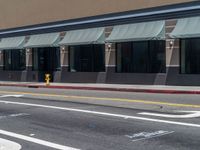 a car parked on the side of the road in front of a storefront,