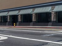 a car parked on the side of the road in front of a storefront,