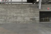 a concrete wall in an empty parking garage area at a construction site on a sunny day