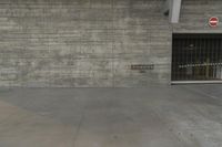 a concrete wall in an empty parking garage area at a construction site on a sunny day