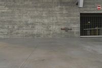 a concrete wall in an empty parking garage area at a construction site on a sunny day