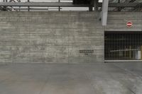 a concrete wall in an empty parking garage area at a construction site on a sunny day