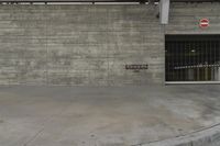 a concrete wall in an empty parking garage area at a construction site on a sunny day