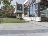 this contemporary home has large outdoor patios to relax outside it's glass doors