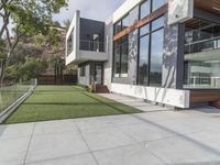 this contemporary home has large outdoor patios to relax outside it's glass doors