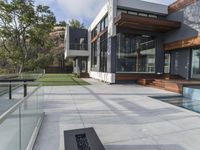 this contemporary home has large outdoor patios to relax outside it's glass doors