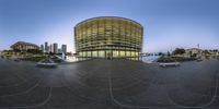 the spherical photograph shows a parking lot and a building in front of it in an otherwise empty circle