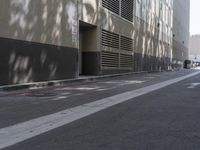 a motorcycle is parked at the curb on a street with buildings in the background and no cars on it