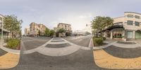 360 - view of an intersection with pedestrian crossing at one corner, a sidewalk and several houses are visible