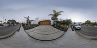 a fish eye view shows cars on the side of the street and in a driveway