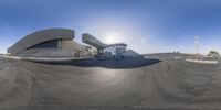 this is a panorama of the exterior of an architectural building with a ramp and a street light