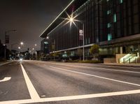 a white arrow symbol on the street with buildings and night sky in the background of this photo