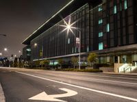 a white arrow symbol on the street with buildings and night sky in the background of this photo