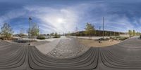 a large skate park with a big sky overhead it's photo taken in a fish eye lens