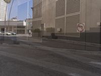 a street with tall buildings and a stop sign on the street near a traffic signal