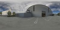 the 360 camera is turned into a very odd photo of two circular buildings and parking lot