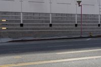 a man is riding his motorcycle on the side of the street with traffic light on