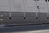 a man is riding his motorcycle on the side of the street with traffic light on