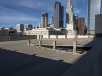 a rooftop with a cityscape in the back ground and sky scrapers with skyscrapers above